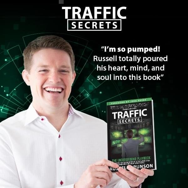 Russel Brunson smiling With his new book traffic secrets